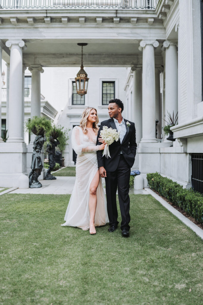 Bride and groom walk together at armstrong kessler mansion wedding in Savannah, Ga.