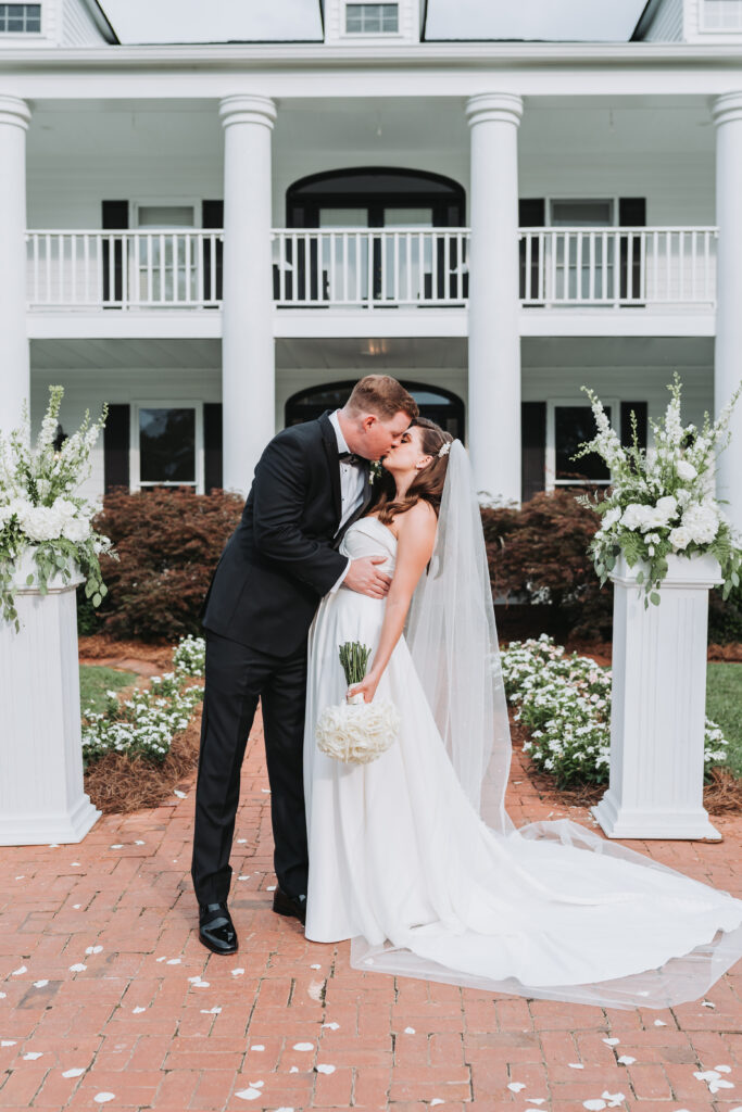 Groom and Bride kiss during their summer wedding at Sanctuary Estates.