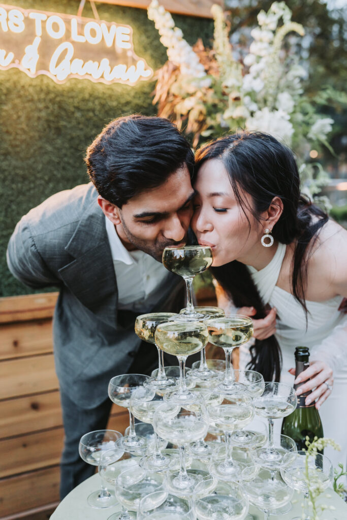 Bride and groom sip champagne together at epicurean hotel wedding.