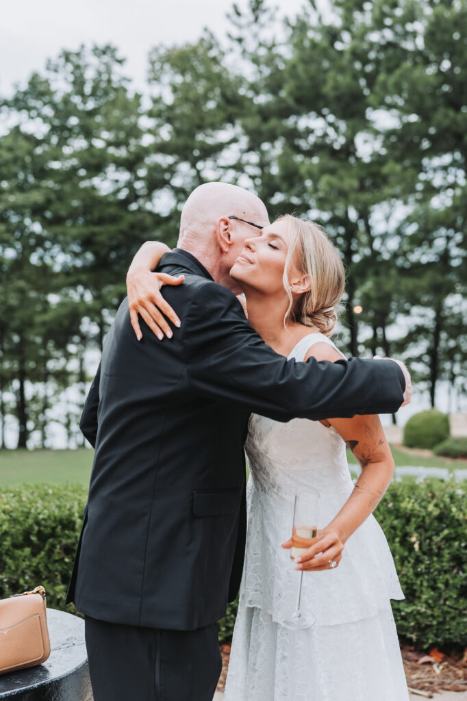 Father hugs bride at Wedding at Lake Lanier Legacy Pointe