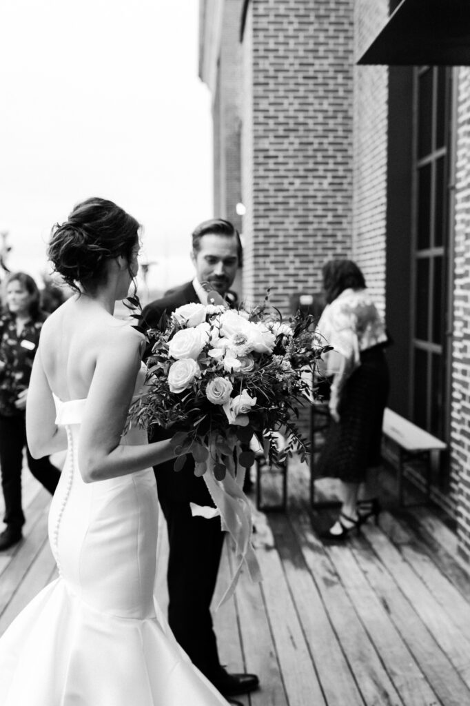 bride and groom walk towards ponce city rooftop ceremony