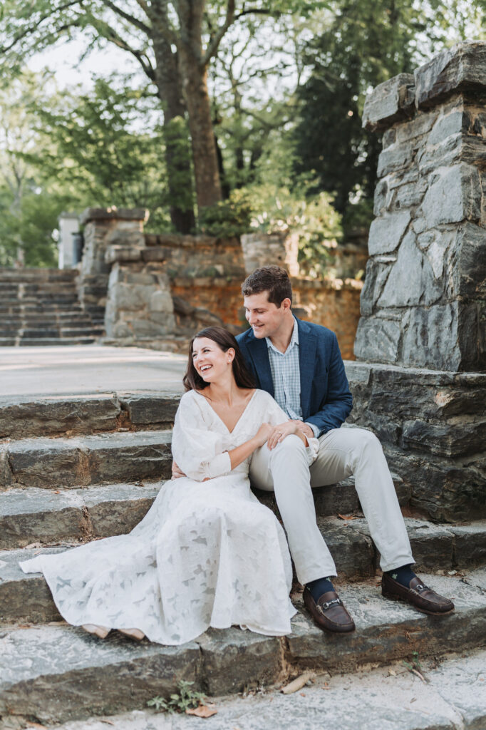 Couple looks off to the side and smiles during their piedmont park engagement session.