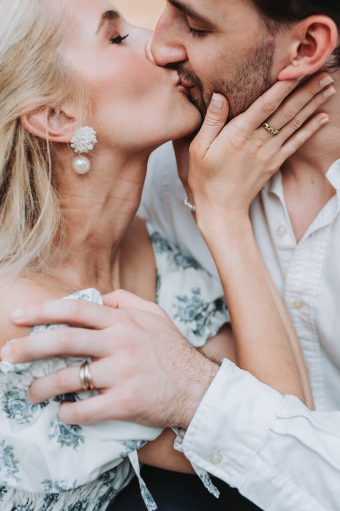 woman kisses man during their Serenbe engagement shoot