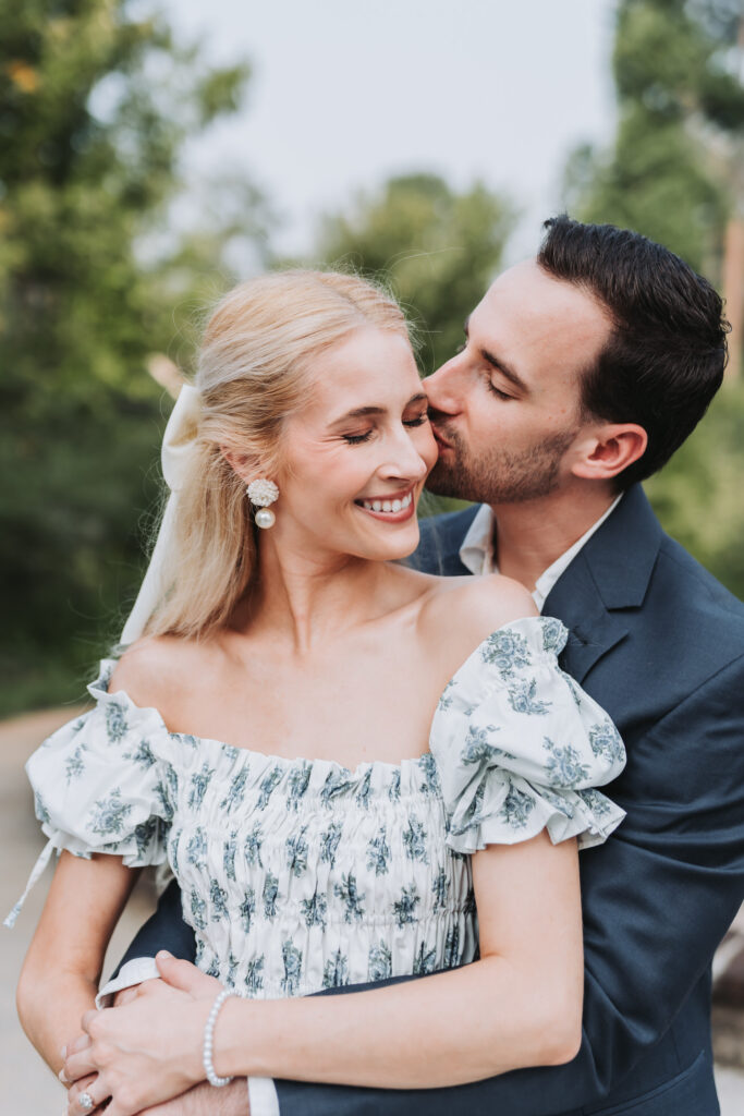 man kisses woman during their Serenbe engagement session