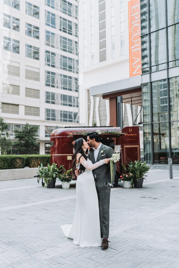 Bride and groom kiss in front of epicurean hotel atlanta
