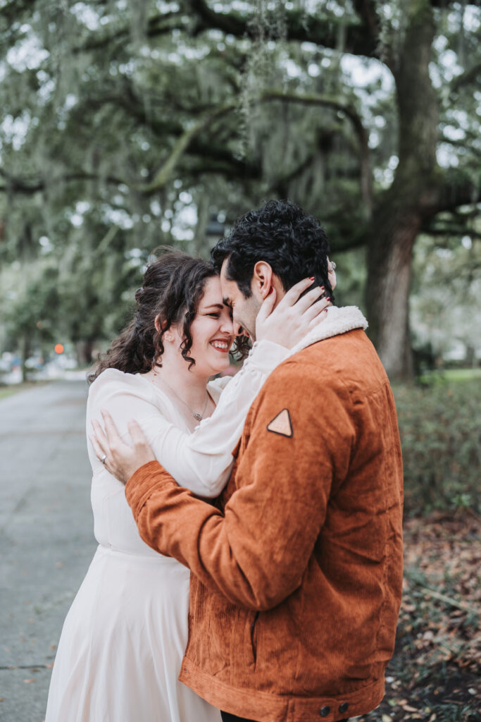 Groom and Bride touch foreheads at Forsyth Park