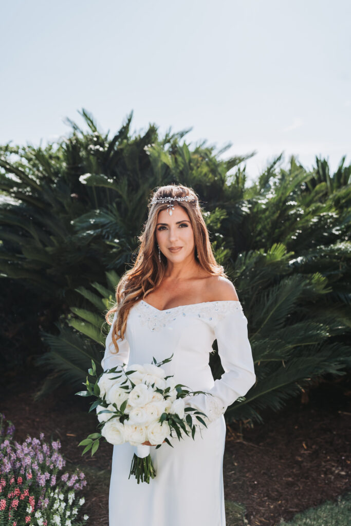 Bride holds flowers and looks at camera at The Westin Savannah Harbor Golf Resort & Spa wedding venue
