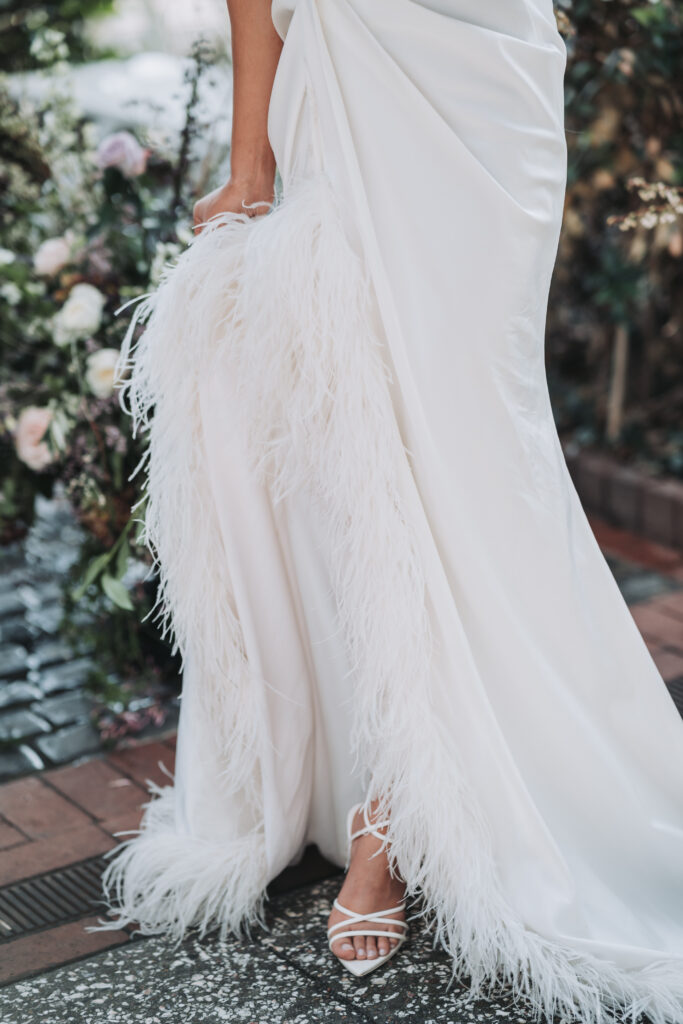 Feather trim modern wedding dress from Ivan Young.
