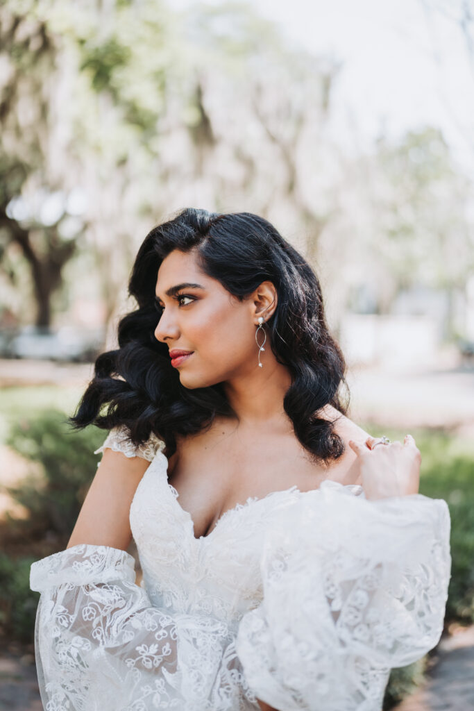 Bride plays with hair as she looks off into the distance