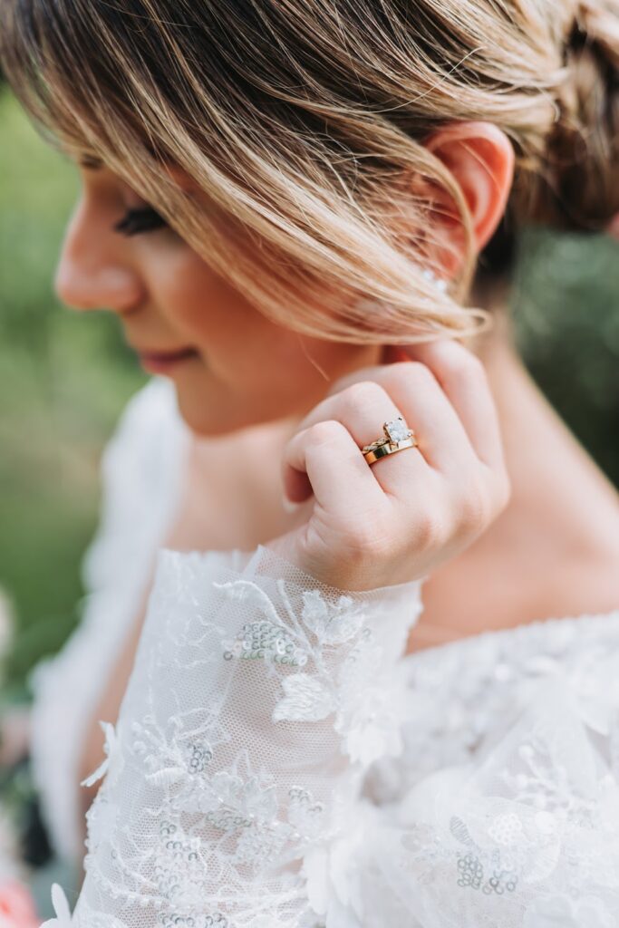 bride photographed showing off wedding ring