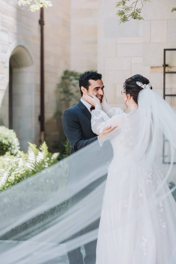A wedding photographer captures a couple gazing at each other at their wedding