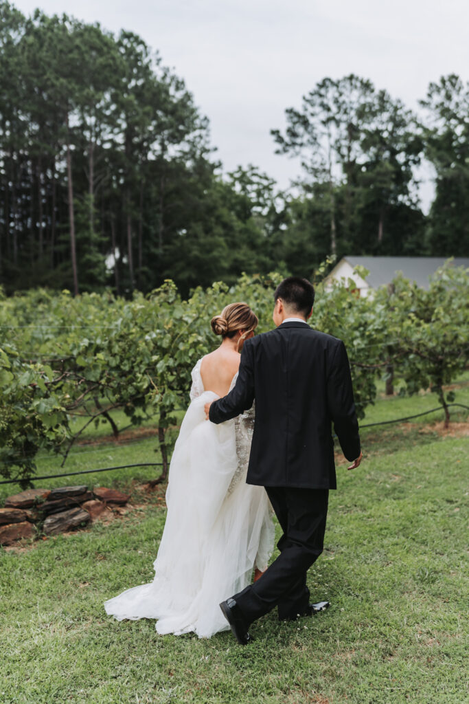 Bride and groom walk through Winery Wedding Venues in Georgia.