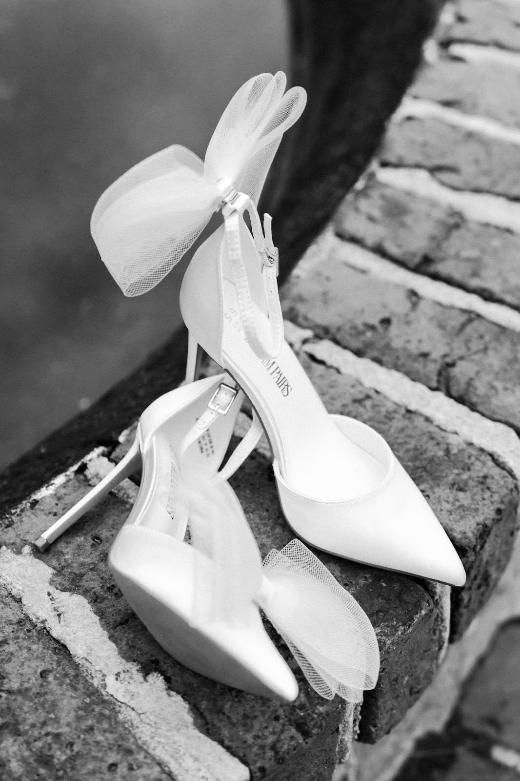 a pair of bridal shoes on a brick arch