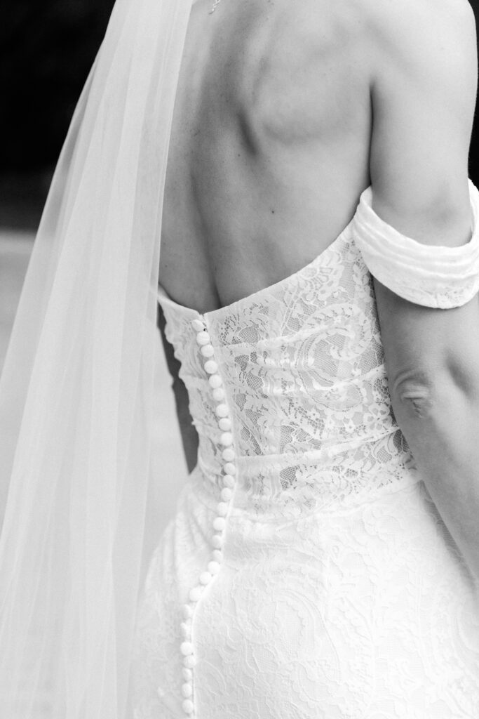 black and white photo of back of bride's lace dress