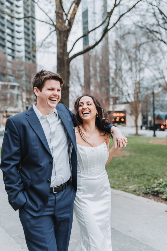 Guy and woman laugh while walking to proposal area in atlanta
