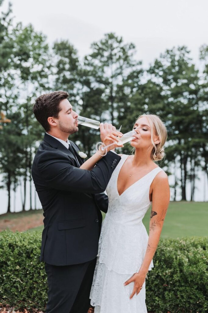 Bride and groom drinking champagne at outdoor wedding in Atlanta