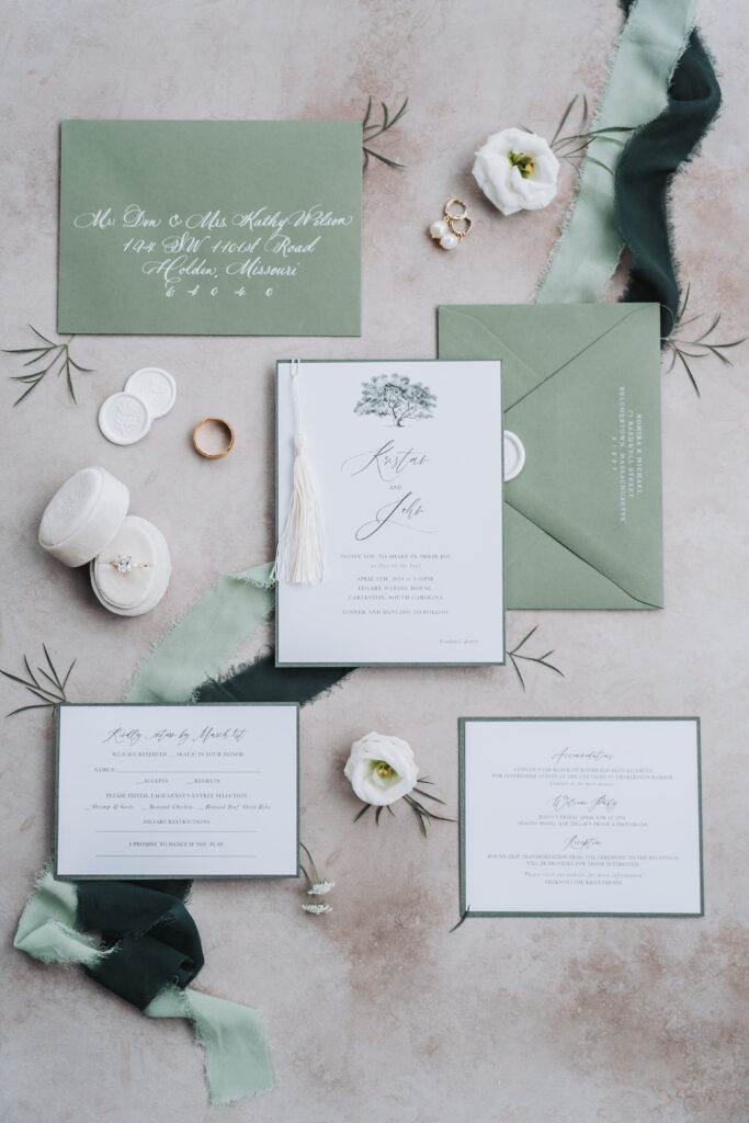save the date and wedding invitations on a table with flowers