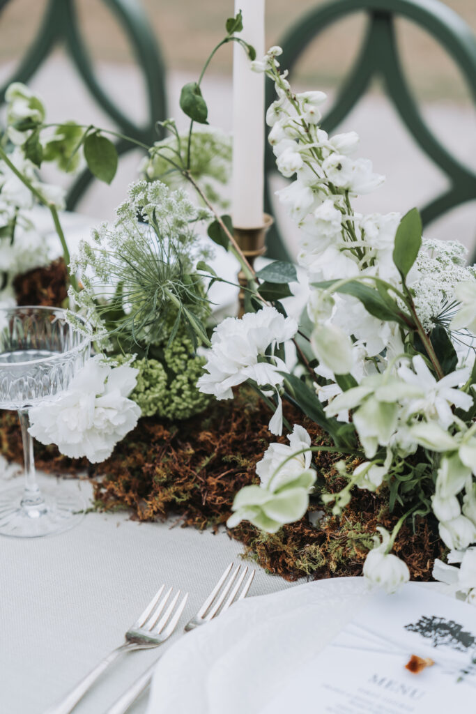table floral arrangement with greenery and spanish moss