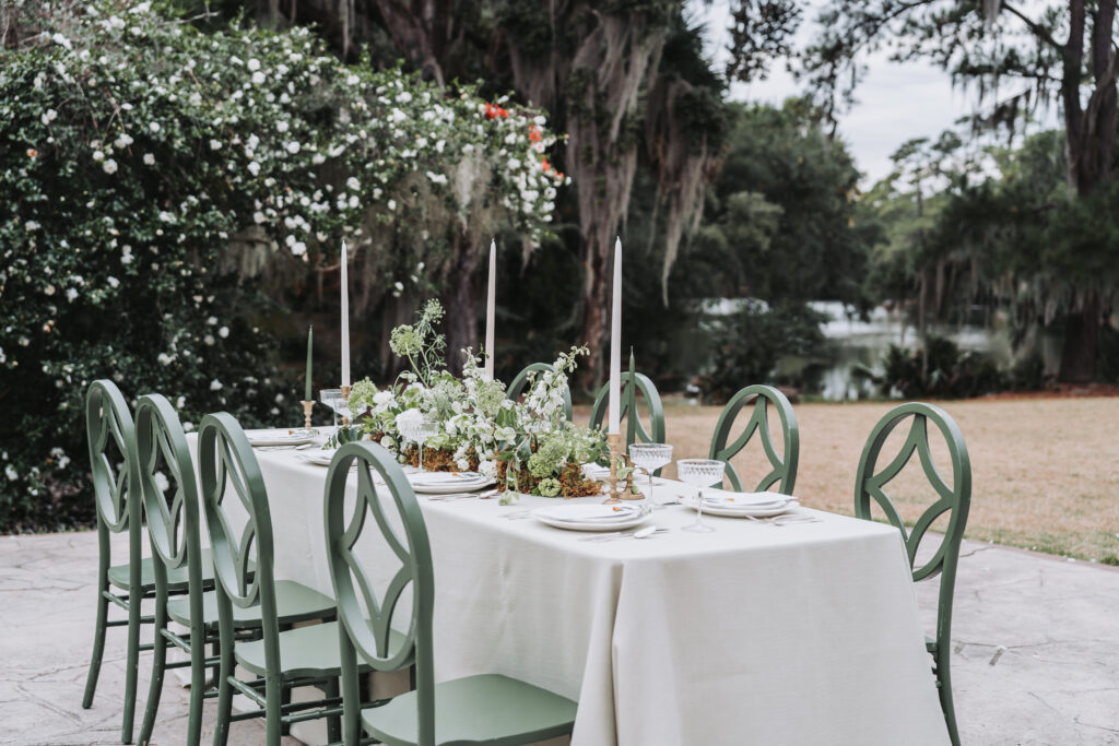 Reception table with green hues and spanish moss greenery