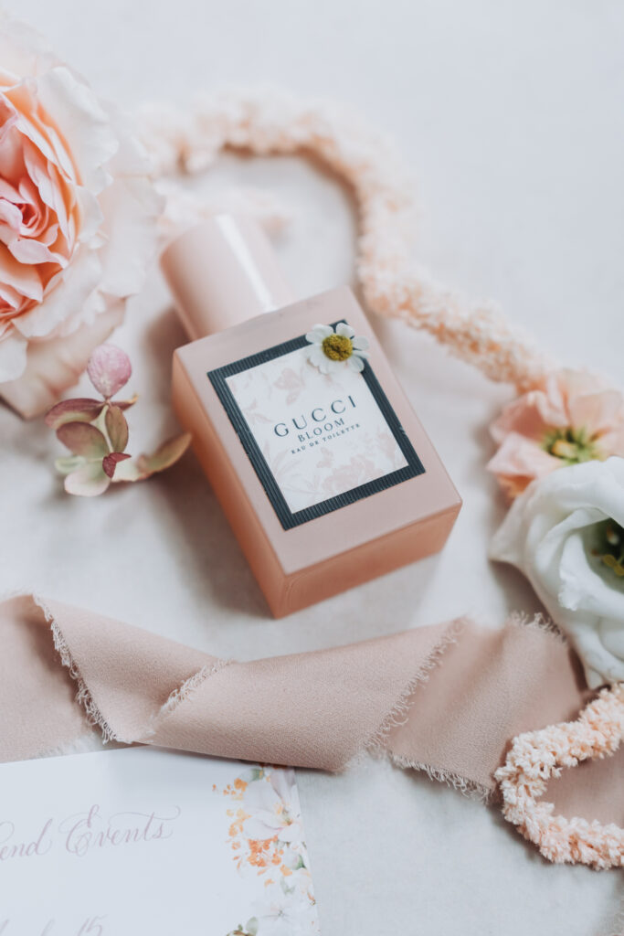 gucci bloom perfume bottle in wedding flat lay