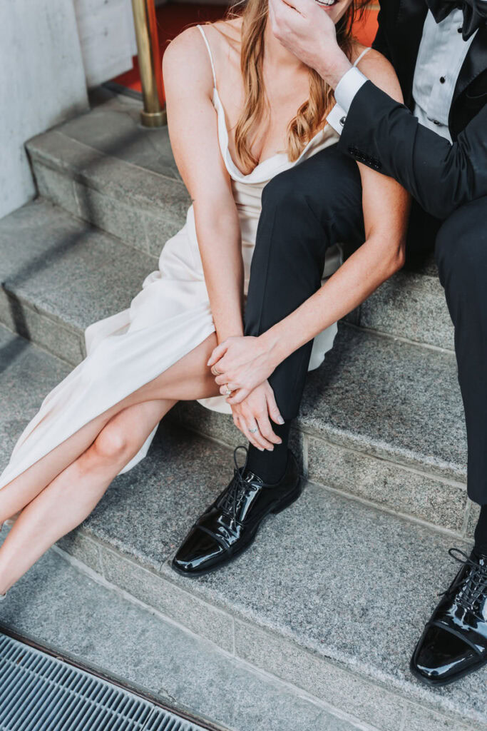 closeup of girl leaning on guy's leg.