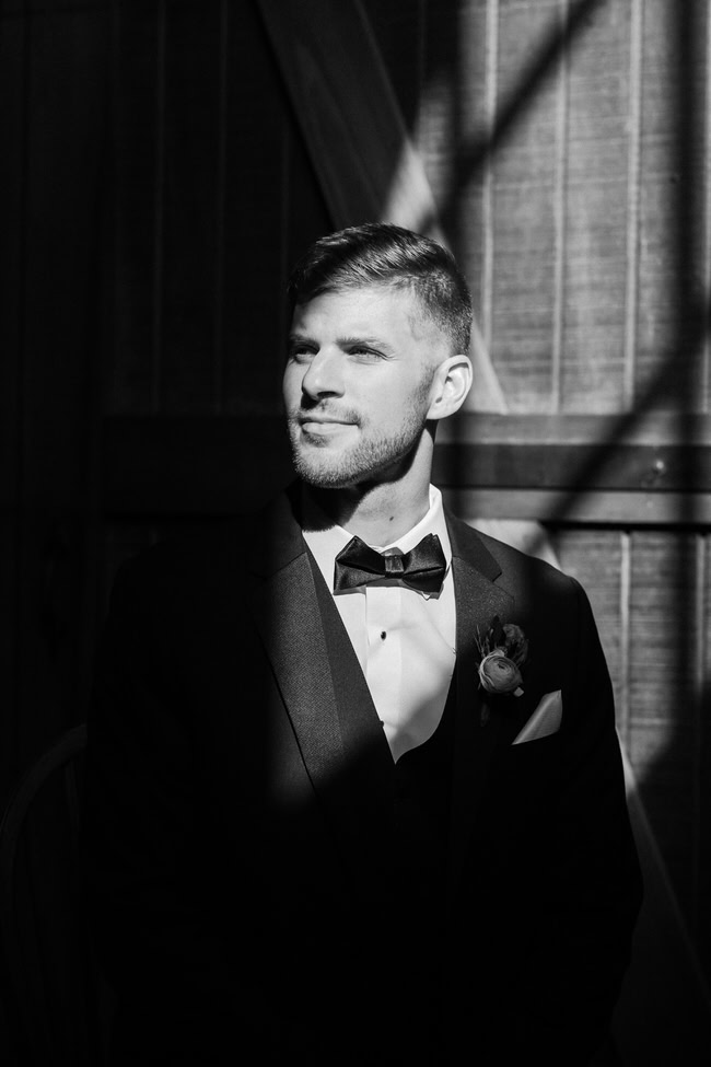 black and white of groom looking off into distance