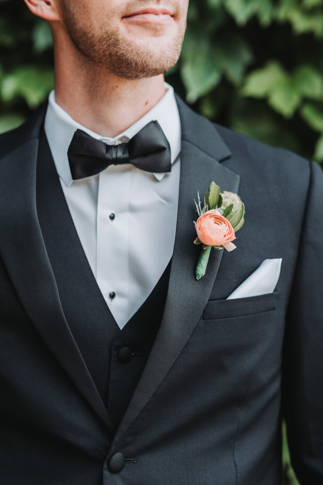 up close photo of groom's tux and boutonniere