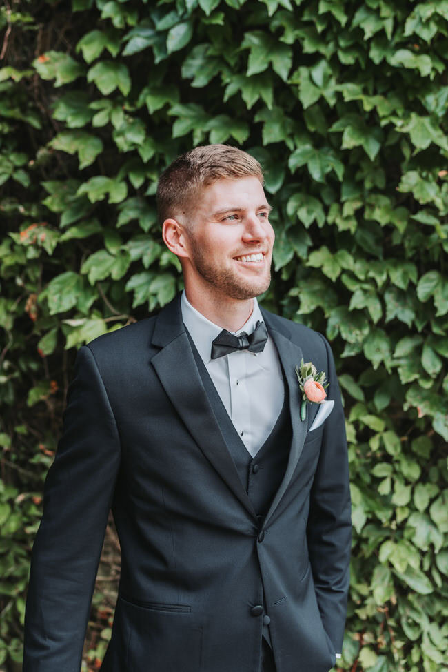 groom looks off for portrait