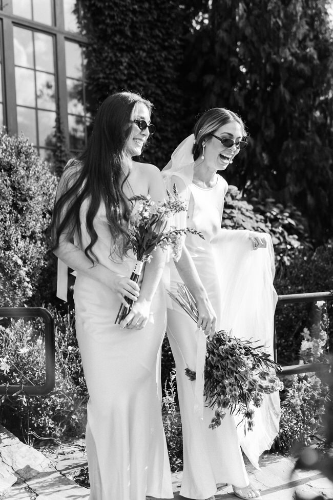 black and white photos of bride and bridesmaid laughing on wedding day.