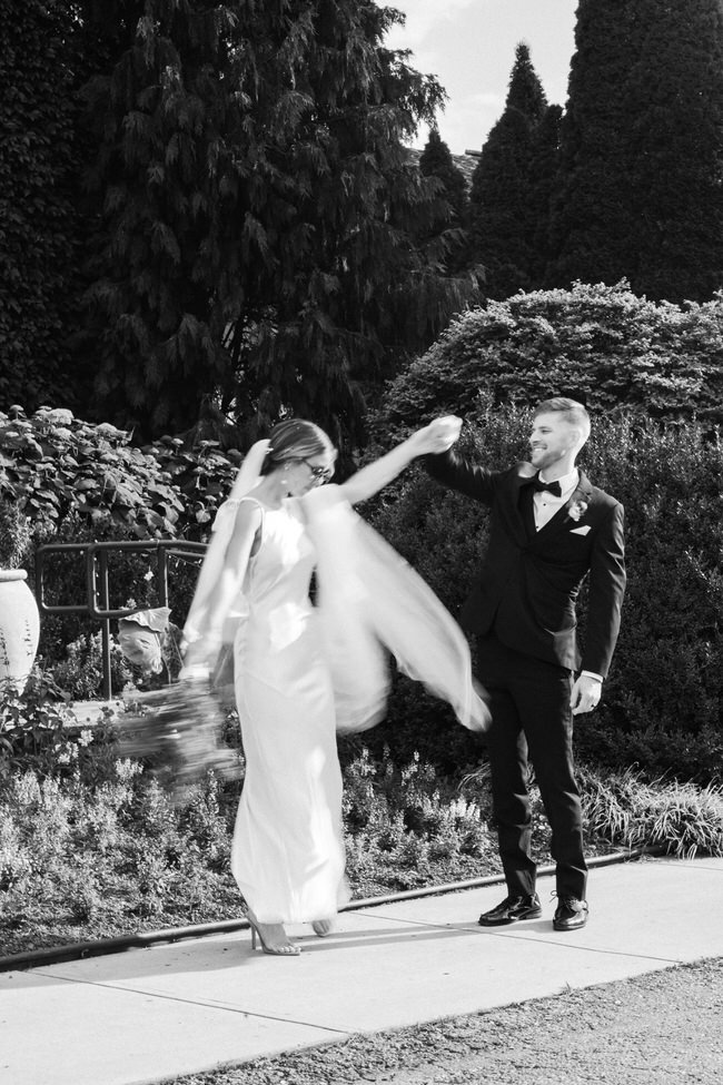 groom spins bride in front of Montaluce wedding venue.