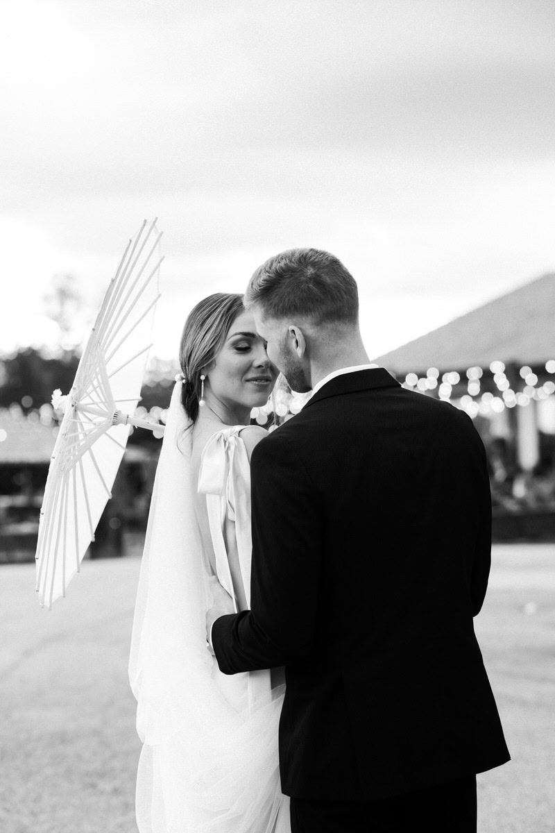 groom holds bride close.