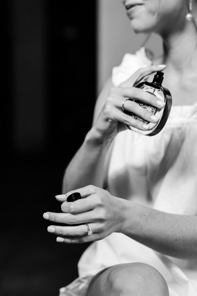 bride sprays perfume.