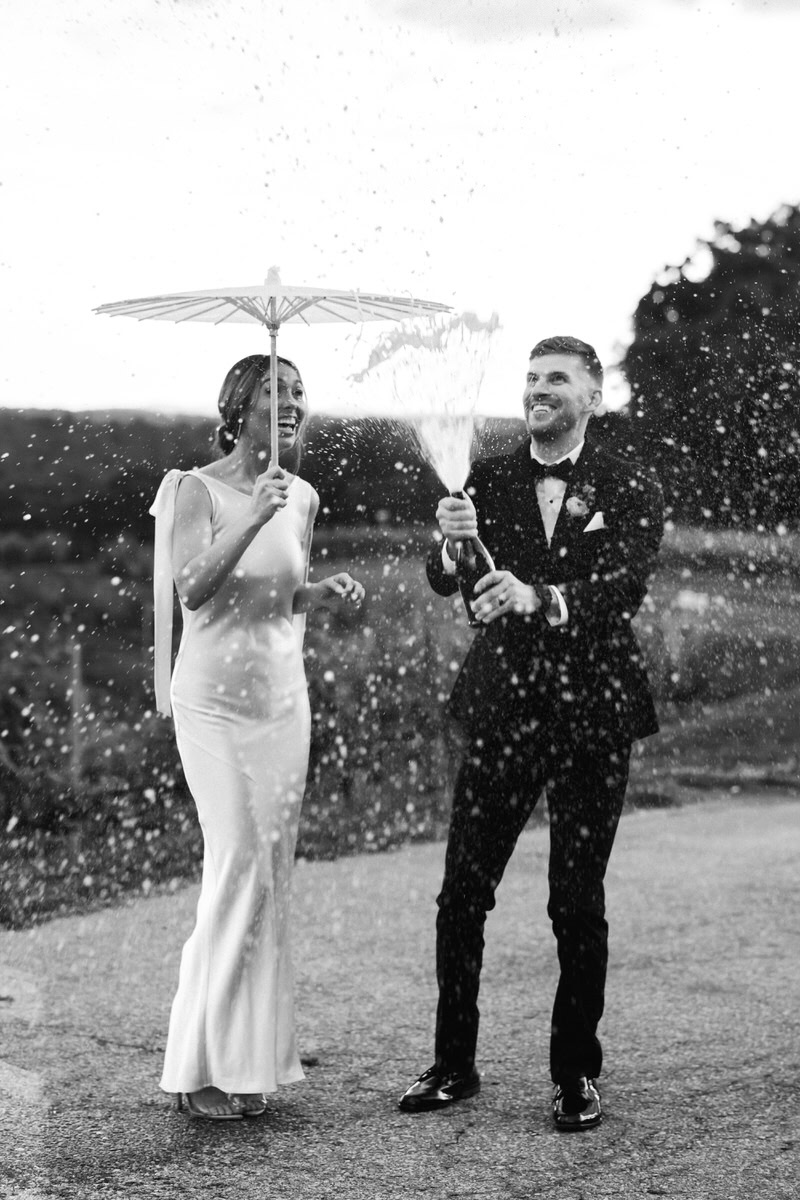 bride and groom pop champagne bottle.