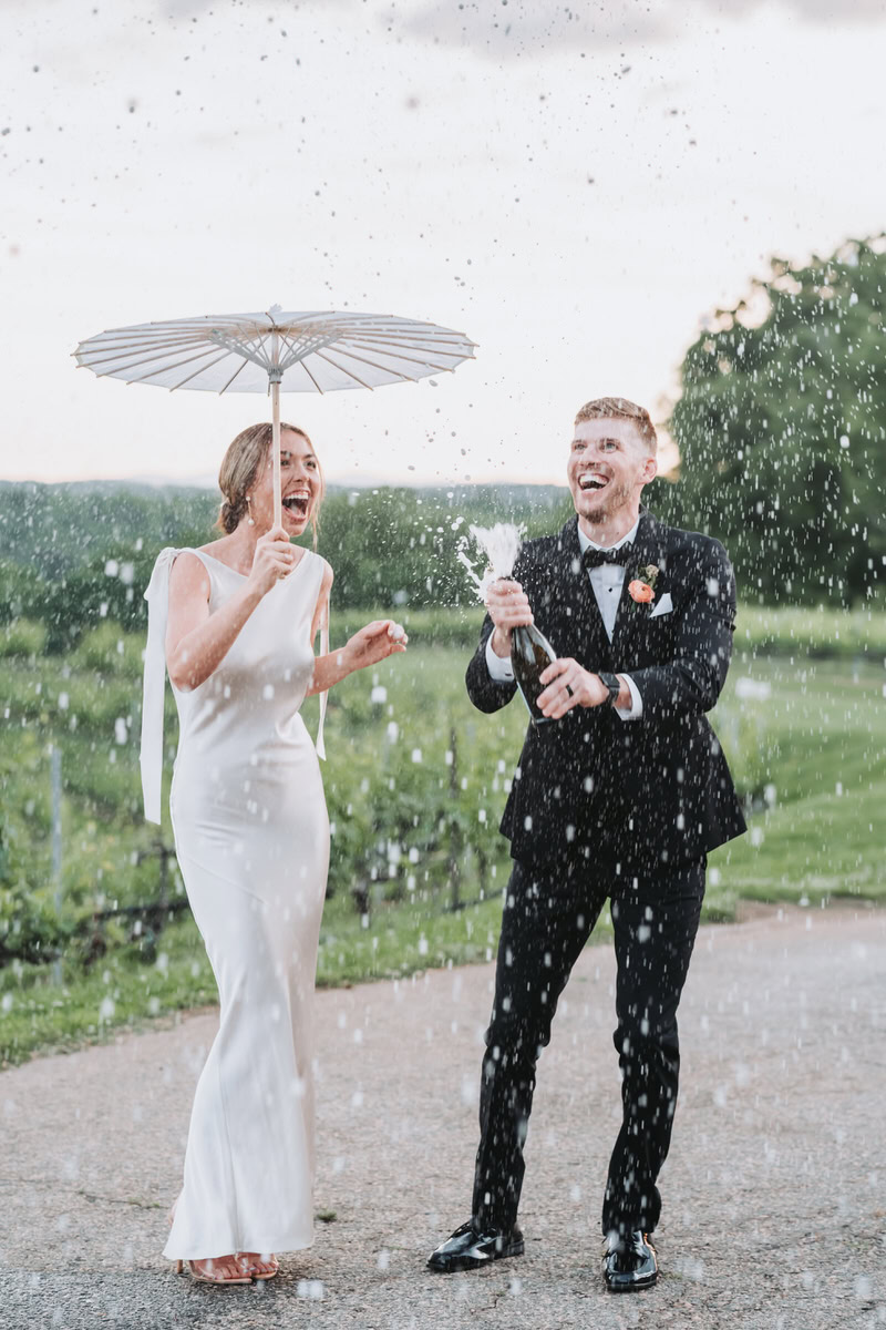 bride and groom pop champagne.