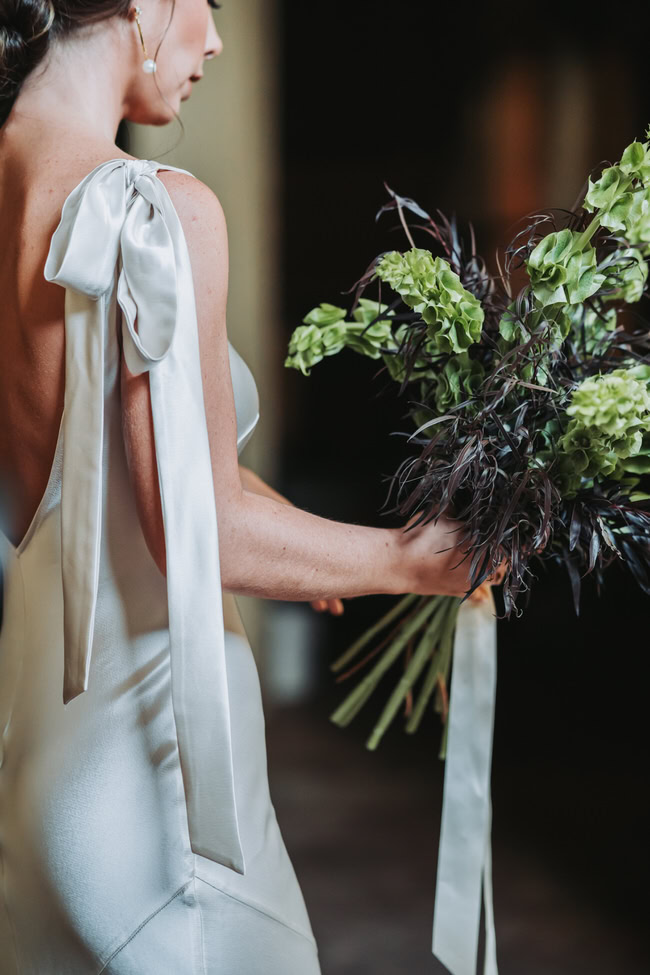 bride touches her flowers