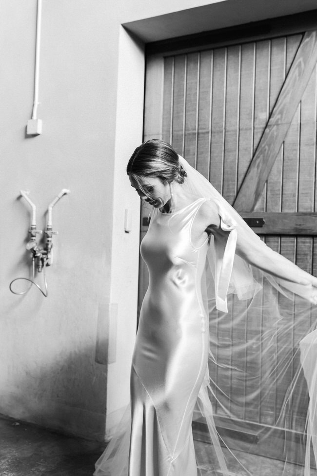 bride holds wedding veil.