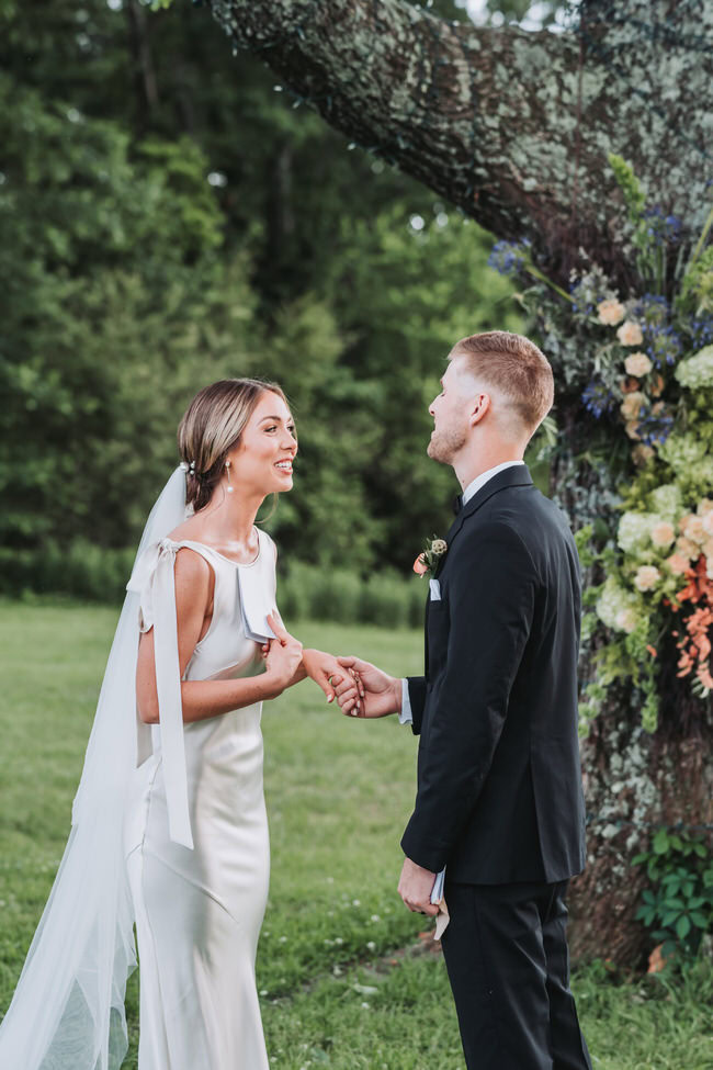 bride and groom read their vows during their ceremony.