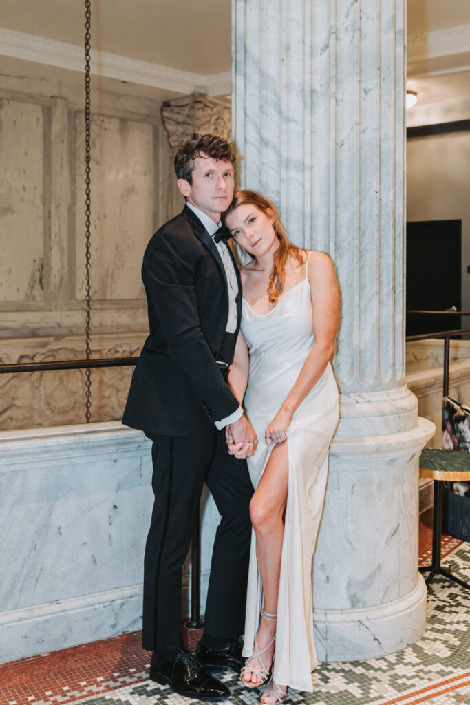 girl and guy lean in and smile at the camera.