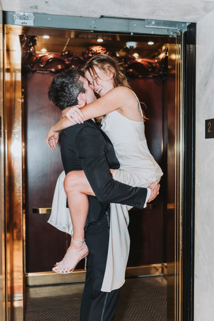 guy holds girl up in the elevator 