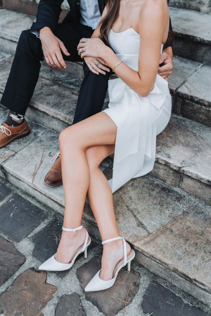 up close photo with a White dress with a bow on it and white heels