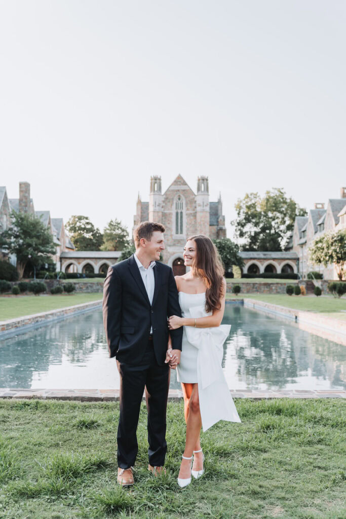 couple looks at each other while standing in front of the Ford Fountain at Berry College