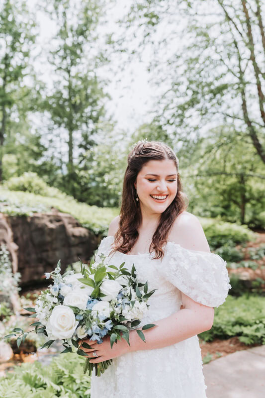 bride giggles as she looks over her shoulder