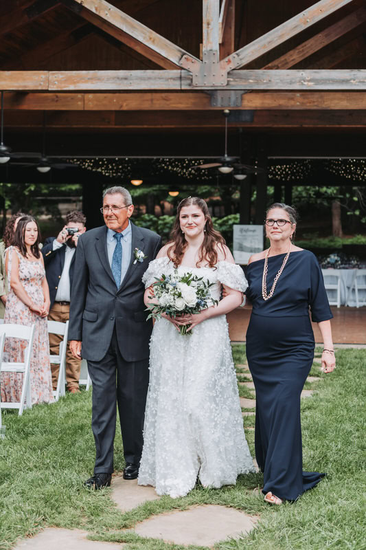 parents walk bride down the aisle