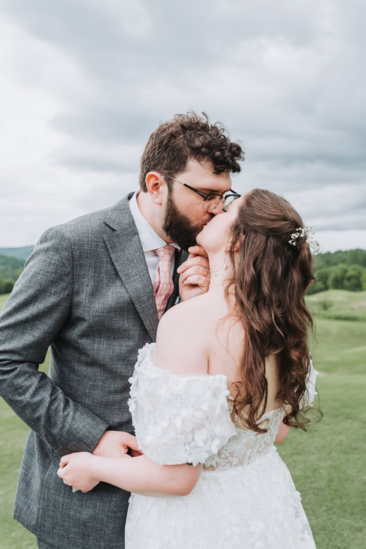 groom pulls bride in for a kiss