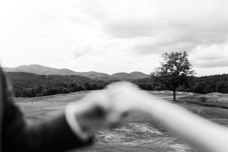 holding hands with mountain in the distance