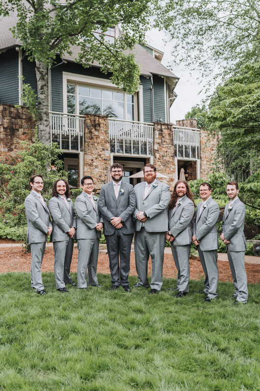 groom and groomsmen smile for camera