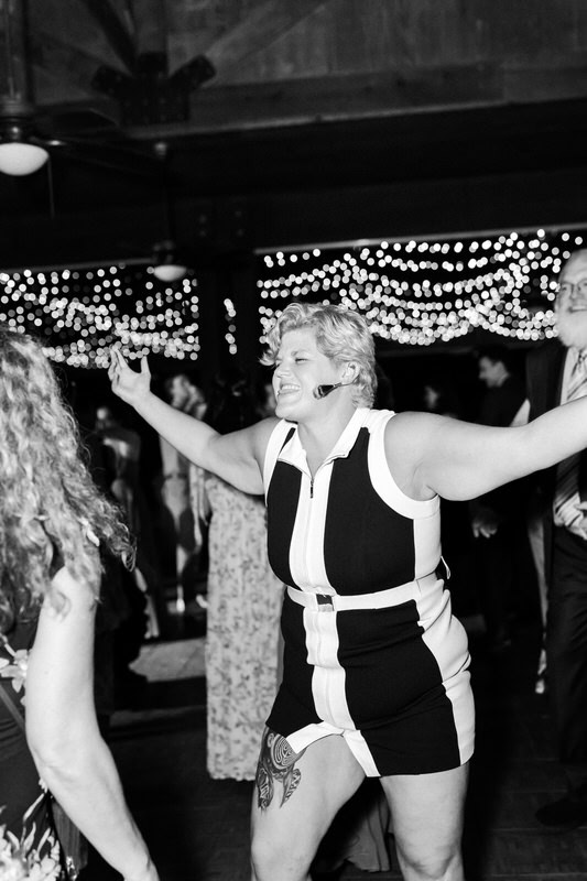 Girl dances with arms out during wedding reception