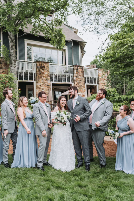 Wedding party laughs at camera