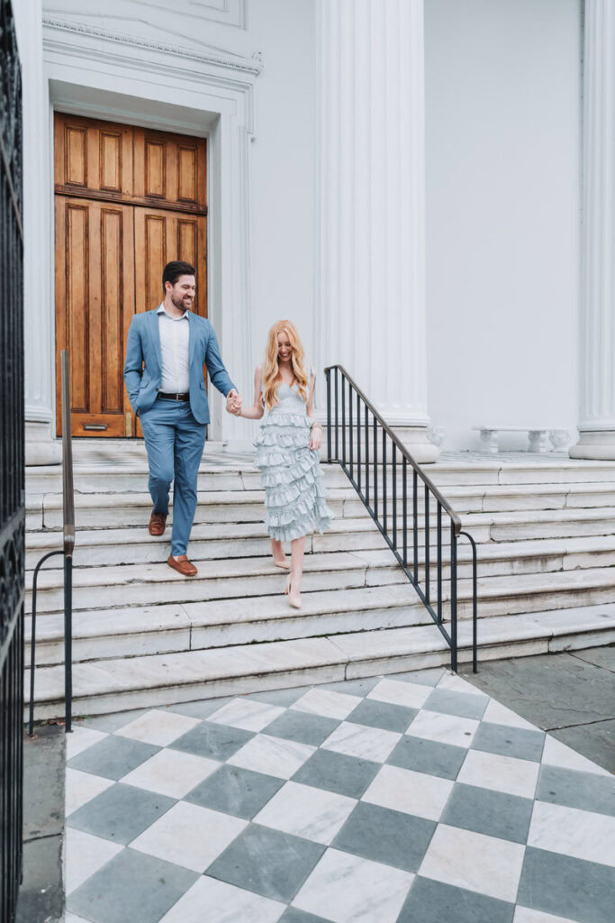 girl and guy walk down steps in historic Charleston South Carolina