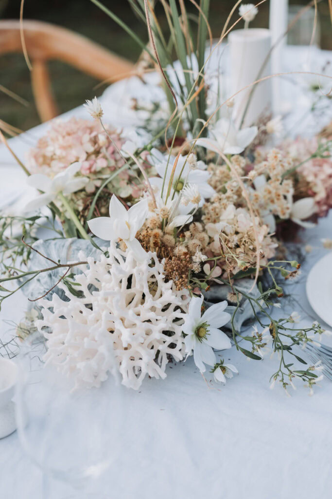 wedding table decorations using beach shells and beach native greenery